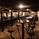 The interior of a pub reveals wooden tables and stools
